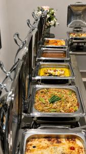 a row of trays filled with different types of food at Maea wade ram in Disah