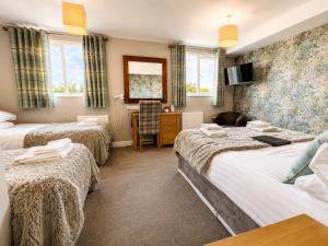a hotel room with three beds and a desk at Hedley House Hotel Wellness and Spa in York +116 photos