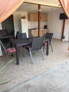 a black table and chairs in a room with a kitchen at Casa Theopa in Corbu