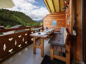 a table and chairs on a balcony with a view at Apartment Mon Abri B by Interhome in Les Diablerets
