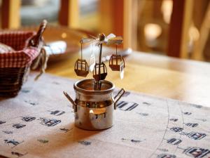 a candle in a metal jar on a table at Apartment Mon Abri B by Interhome in Les Diablerets +31 photos