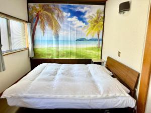 a bed in a room with a large window at Guest house En in Fujiyoshida