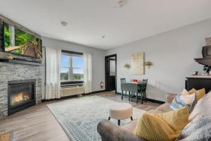 a living room with a couch and a fireplace at The Serenity Suite with Hot Tub- Main Street Lodge in Berlin in Berlin