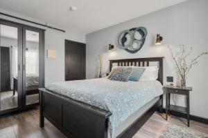 a bedroom with a bed and a mirror on the wall at The Serenity Suite with Hot Tub- Main Street Lodge in Berlin in Berlin