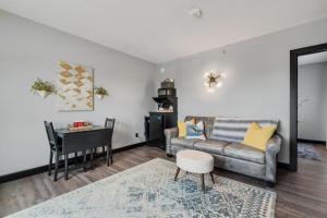 a living room with a couch and a table at The Serenity Suite with Hot Tub- Main Street Lodge in Berlin in Berlin