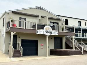 a house with a sign that reads hotel lodge at The Serenity Suite with Hot Tub- Main Street Lodge in Berlin in Berlin