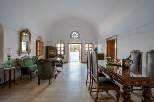 a dining room with a table and chairs at Casasantantonio 18th Century Luxury Mansion in Fira