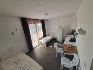 a living room with a bed and a table in a room at Apartments Lozenets in Lozenets
