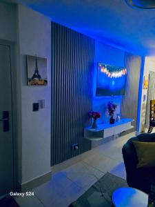 a blue room with a couch and a table at Peace Place in Santiago de los Caballeros