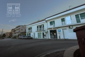 a street with a white house with a car parked in front at The White House in Miglianico