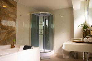a bathroom with a shower and a tub and a sink at Hotel Terra in Arequipa +40 photos