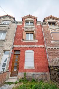 an old red brick building with a door at T2 Cosy - Amiens Centre - Wifi in Amiens