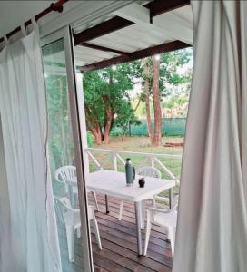a white table and chairs on a wooden deck at La Morada en Funes in Funes