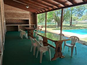 a patio with tables and chairs and a pool at La Morada en Funes in Funes