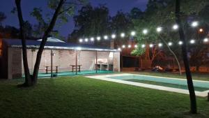 a house with a swimming pool at night with lights at La Morada en Funes in Funes