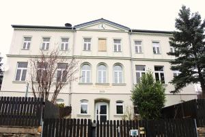 a white building with a fence in front of it at Schullandheim Neukirch Lausitz in Meyershäuser +4 photos