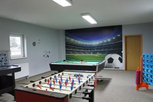 a room with a table with a soccer ball mural at Schullandheim Neukirch Lausitz in Meyershäuser