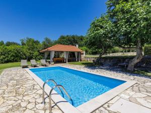 a swimming pool in a yard with a gazebo at Villa Elli by Interhome in Tinjan