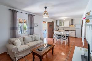 a living room with a couch and a table at Cubo's Charming House Las Millanas in Tolox