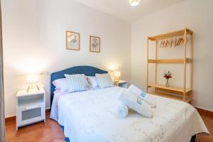 a bedroom with a blue bed with two pillows on it at Cubo's Charming House Las Millanas in Tolox +27 photos
