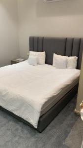 a large bed with white sheets and pillows at The Mountain View in Al Namas in Al Namas +30 photos
