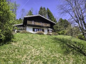 a house sitting on top of a grassy hill at Chalet Chalet chemin du four by Interhome in Morgins