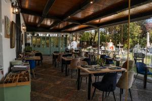 Ein Restaurant mit Tischen und Stühlen und einer Person im Hintergrund in der Unterkunft Hacienda El Santiscal in Arcos de la Frontera