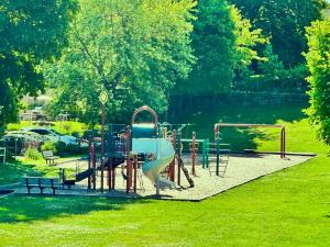 a playground with a slide in a park at Properties by Menjivar in Beverly