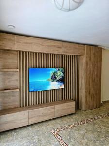 a flat screen tv sitting on top of a wooden wall at Entire Apartment near Valencia - 2 Bedrooms & 2 Bathrooms in Paterna
