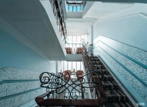 a spiral staircase in a building with a window at Гостиница Роза in Almaty