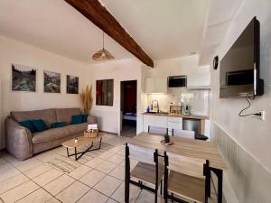 a living room with a couch and a table at Chez Mel et Garry in Villedaigne