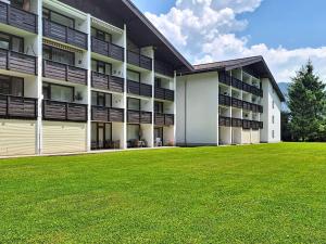 an apartment building with a green lawn in front of it at Apartment Grubhof by Interhome in Scheffsnoth