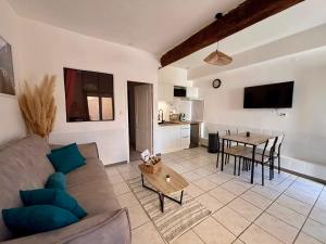 a living room with a couch and a table at Chez Mel et Garry in Villedaigne