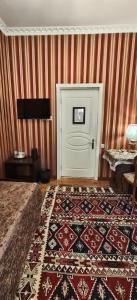 a room with a white door and a rug at Retro Silent Boutique Hotel in Baku
