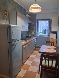 a kitchen with a refrigerator and a table at Przystanek Kraszczady in Krasnystaw +17 photos