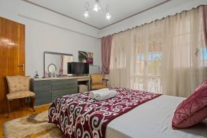 a bedroom with a bed and a desk with a computer at Villa Amalia Laconia in Dháfnion
