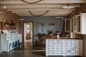a kitchen with white cabinets and a wooden table at Agriturismo Campoletizia in Miglianico