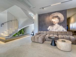a living room with a couch and a painting at Villa Loparia by Interhome in Lopar