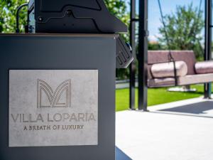 a sign for a park with a bench at Villa Loparia by Interhome in Lopar