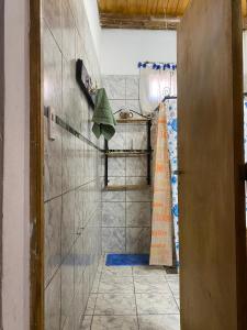 a bathroom with a shower and a tiled wall at Complejo el cordobes in Albardón +16 photos