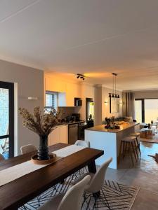 a kitchen and living room with a table and chairs at Cosy Langdown Getaway in Plettenberg Bay