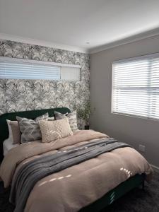 a bedroom with a large bed and a window at Cosy Langdown Getaway in Plettenberg Bay