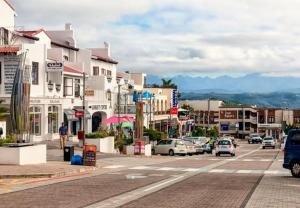 a busy city street with cars and buildings on a city at Cosy Langdown Getaway in Plettenberg Bay