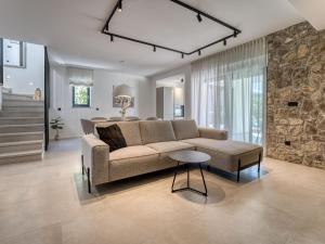 a living room with a couch and a table at Villa Dream by Interhome in Dobrinj