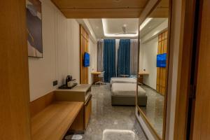 a hotel room with two beds and a mirror at Hotel Vintana in Nananpur