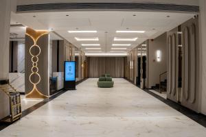 a hallway in a building with a couch in the middle at Hotel Vintana in Nananpur