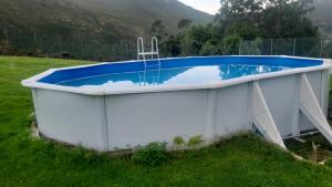 a large hot tub in a field with a hill at Apartamento Casa Manuela, a 8 km de la playa AR1550AS in Llanes