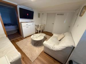 a living room with a white couch and a table at LaSa Apartment 2 in Villingen-Schwenningen