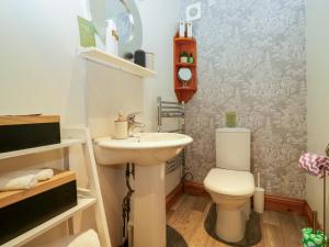 a bathroom with a toilet and a sink at La'al Yan in Workington +28 photos