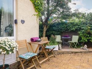 a patio with chairs and a table and a table and chairs at La'al Yan in Workington